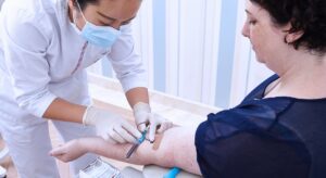 Medical professional performing blood test